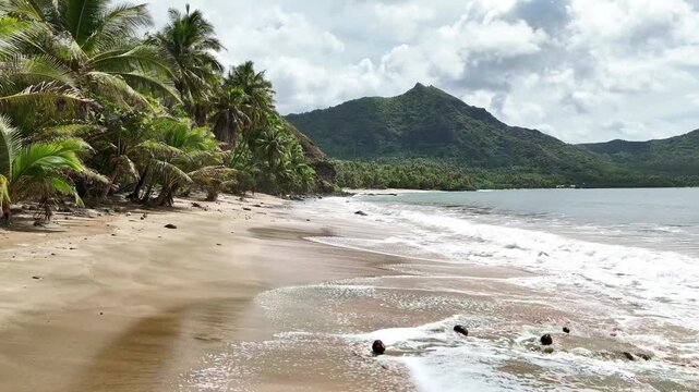 Drone Marquesas Islands. Aerial view Nuku Hiva island in French Polynesia. Tropical beach, palm trees and clear ocean water. Exotic travel vacation getaway, romantic paradise tourism destination. 