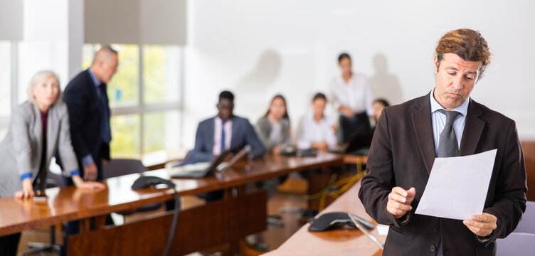 Depressed mid aged white male employee feeling guilty and frustrated while being scolded by furious female boss for bad work result and declining project rates in financial report during corporate
