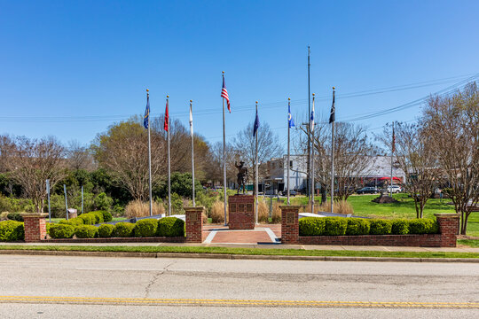 FORT MILL, S.C.-2 APRIL 22: Veterans Park in downtown, with monument and flag poles.
