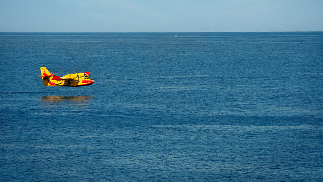 rescue aircraft landing on the sea to put water in. operation to extinguish a forest fire.
