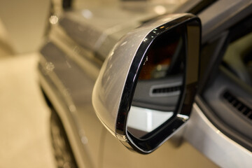 An elegant closeup shot of a sleek car side mirror showcasing its design and details