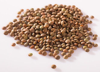 Pile of raw lentil grains on white background. Organic food for healthy eating..