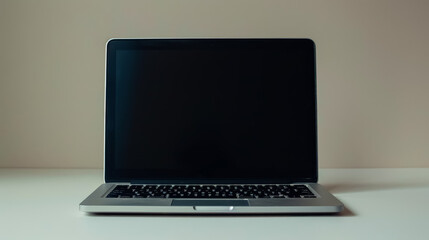 Fototapeta premium Silver laptop is open on a table.