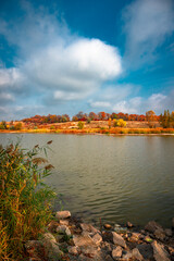 Lake near the forest at autumn.Fall landscape with river and trees,golden colors.Water in the forest.Pond near the forest.Woodlands in the autumn colors 