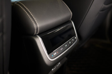 The car features a high end interior, but shows wear and tear with a armrest