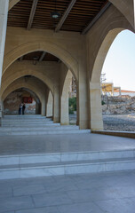 Exploring beautiful stone arches beneath a historic building in the quiet afternoon light.