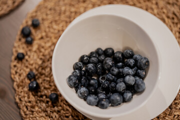 Fresh healthy nice big blueberries inside white modern tray. Tasty early vitamins of berries top view