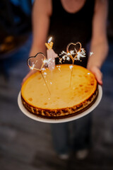 Sparkle candles on home made cheesecake with heart shaped candles