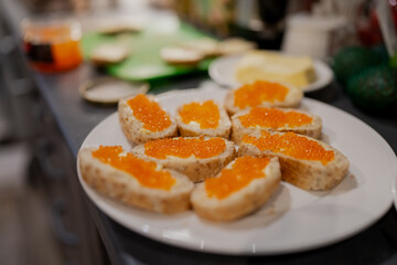 Orange caviar on white bread with butter. Slavic and Baltic typical cuisine for breakfast in the weekend