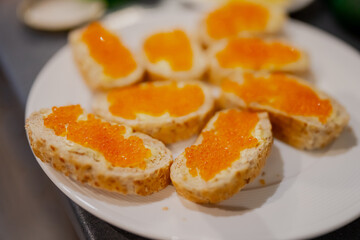 Orange caviar on white bread with butter. Slavic and Baltic typical cuisine for breakfast in the weekend