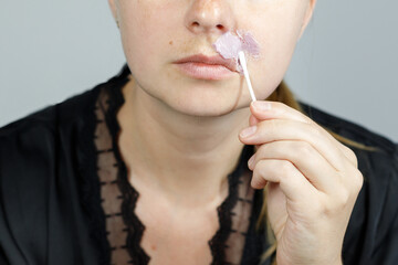 close up of woman waxing facial hair