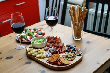 wine snacks on a wooden tray in the kitchen