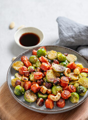 Brussels sprouts with chorizo ​​sausages, nuts and sesame seeds in soy sauce.