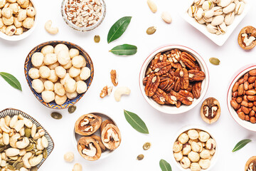 Assortment of fresh dry nuts and seeds on white background top view. healthy vegan food concept.
