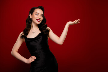 Stunning attractive rich lady millionaire presenting empty space isolated on red color background