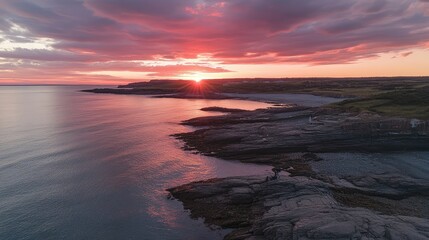 Breathtaking Sunset Over Serene Coastal Landscape with Vibrant Colors Reflecting on Calm Waters and Rocky Shoreline, Perfect for Nature and Travel Enthusiasts