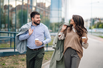 Business people walking and talking during coffee break