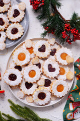 Traditional Christmas Linzer Cookies on a Christmas rustic background