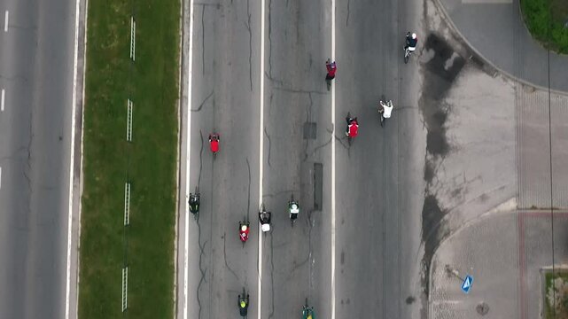 A group of cyclists are riding along the road, competing with each other in a bicycle race in the middle of the city. Bicycle race among professional athletes along the city road