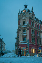 Fototapeta premium Snowy winter cityscapes with historic architecture and modern structures