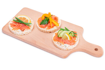 Rice Cake Sandwiches with Fresh Salmon, Cucumber, Yellow Paprika and Greens on Wooden Cutting Board. Diet Food. Quick and Healthy Sandwiches. Crispbread with Fresh Fillings. Healthy Dietary Snacks