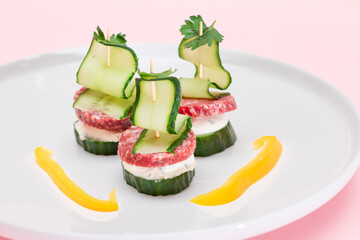 Canapes without Bread with Salami, Cucumber, Greens and Cream Cheese on White Plate. Easy Breakfast. Diet Food. Quick and Healthy Sandwiches. Healthy Snacks with Tasty Fillings