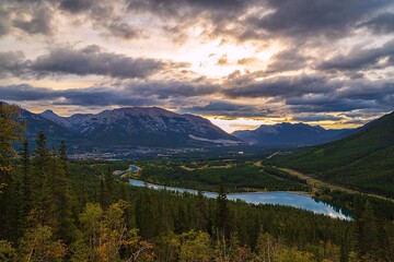 Panoramic View Of A Canmore Lookout Under A Sunlit Cloudy Sky