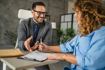 male colleague persuade a female colleague to signing a contract