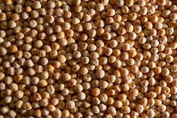 Uncooked Yellow Polished Peas Background. A Culinary Canvas of Dry Yellow Peas, Creating a Lively and Textured Background for Gourmet Cooking. Scattered Raw Polished Peas. Healthy Eating Ingredients