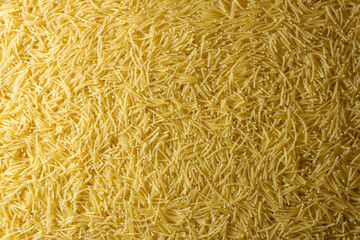 Uncooked Filini Pasta: A Culinary Canvas of Noodles, Creating a Lively and Textured Background for Gourmet Cooking. Dry Pasta. Raw Macaroni - Top View, Flat Lay