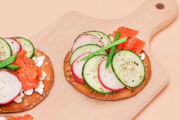 Crispy Cracker Sandwiches with Fresh Salmon, Cucumber, Radish, Cottage Cheese and Green Onions. Easy Breakfast. Quick and Healthy Sandwiches. Crispbread with Tasty Filling. Healthy Dietary Snack