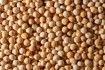 Uncooked Yellow Polished Peas Background. A Culinary Canvas of Dry Yellow Peas, Creating a Lively and Textured Background for Gourmet Cooking. Scattered Raw Polished Peas. Healthy Eating Ingredients