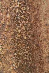 Texture or background of the walls of rusted steel sheets are an orange color, very dark and abstract.
