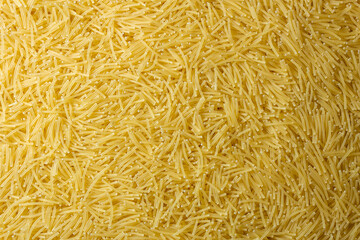 Uncooked Filini Pasta: A Culinary Canvas of Noodles, Creating a Lively and Textured Background for...