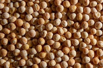 Uncooked Yellow Polished Peas Background. A Culinary Canvas of Dry Yellow Peas, Creating a Lively and Textured Background for Gourmet Cooking. Scattered Raw Polished Peas. Healthy Eating Ingredients