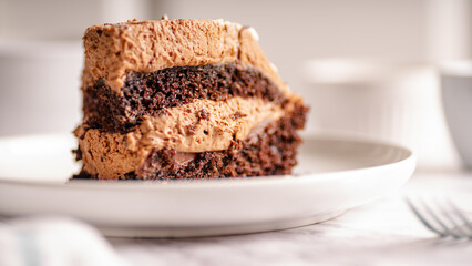 Chocolate Cake Slice on White Plate – Selective Focus

