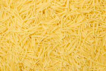 Uncooked Filini Pasta: A Culinary Canvas of Noodles, Creating a Lively and Textured Background for Gourmet Cooking. Dry Pasta. Raw Macaroni - Top View, Flat Lay