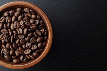 Fototapeta premium A wooden bowl filled with roasted coffee beans on a dark wooden surface, emphasizing the rich textures and warm, earthy tones of the beans in a minimalistic composition