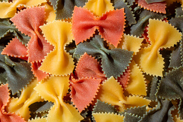 Uncooked Vibrant Colored Farfalle Pasta: A Culinary Canvas of Multicolored Bow-Tie Macaroni,...