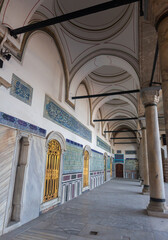 Naklejka premium Architecture of Imperial Topkapi Palace pavilion with vaulted ceiling supported by columns, arches, gilded grilles and bas-reliefs, Istanbul, Turkey.