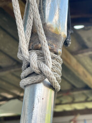 Fototapeta premium a vertical closeup shot of a rope on a ship bridge