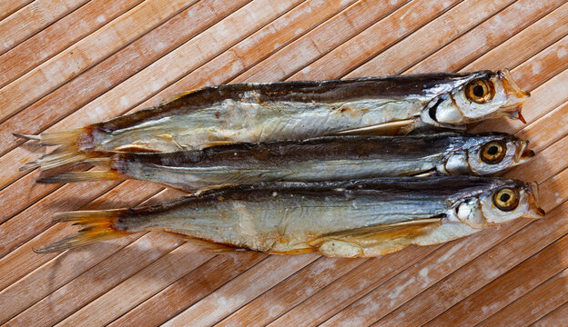 Image of air-dried salted sabrefish on wooden background, nobody