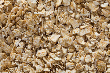 Closeup of oat flakes as background. Concept of healthy food..