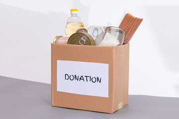 Donation Box of Free Food. Carton Box with Canned Food, Cereals and Grocery. Meal Reserves. Emergency Food Storage in Case of Crisis. Free Social Help, Blessings and Care. Strategic Food Supplies