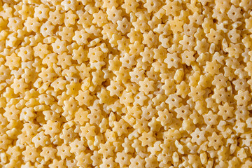 Uncooked Stelline Pasta: A Culinary Canvas of Stelline Macaroni, Creating a Lively and Textured Background for Gourmet Cooking. Dry Pasta. Raw Macaroni - Top View, Flat Lay