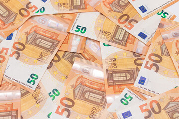 50 Euro Banknotes Money Background. Euro Money Currency. Orange Paper Money. A Lot of Fifty Euro Bills. Business, Finances, Cash and Money Saving Concept