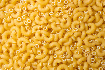 Uncooked Chifferi Rigati Pasta: A Culinary Canvas of Chifferi Rigati, Creating a Lively and Textured Background for Gourmet Cooking. Dry Pasta. Raw Macaroni - Top View, Flat Lay