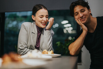 Two high school students share a moment of laughter while enjoying dessert at a cozy cafe. The atmosphere is warm and friendly, highlighting their joyful friendship.