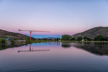 Obraz premium Nottingham lake park in Avon, Colorado in sunrise morning with construction crane in small mountain village town city in fall autumn