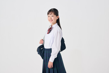 白背景,通学カバンを持った日本人女子中学生
